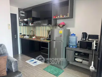 Modern kitchen with sleek black cabinets and stainless steel appliances