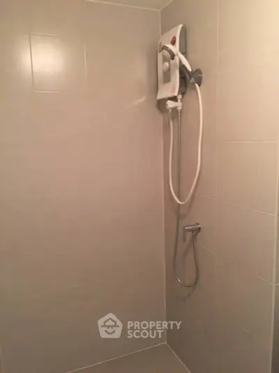 Modern bathroom with sleek shower unit and tiled walls