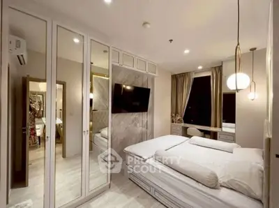 Luxurious bedroom with mirrored closets and modern decor