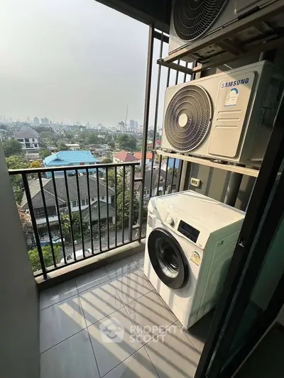 High-rise balcony with city view and laundry appliances, perfect for urban living.