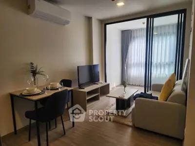 Modern living room with cozy seating and dining area, featuring stylish decor and natural light.