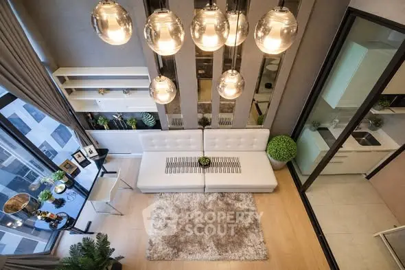 Luxurious modern living room with high ceilings and elegant lighting in a stylish apartment.