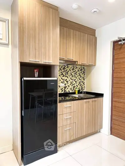 Modern compact kitchen with sleek wooden cabinets and stylish backsplash