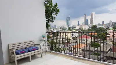 Spacious balcony with stunning city skyline view, perfect for relaxation and enjoying urban living.