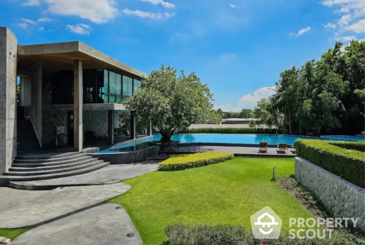 Luxurious modern villa with stunning pool and lush garden view