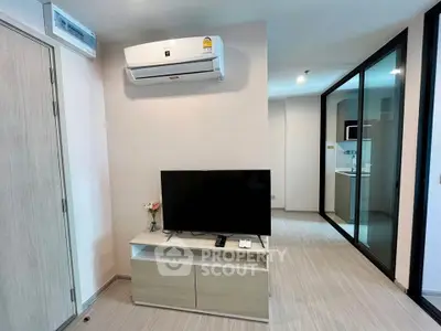 Modern living room with air conditioning and sleek TV setup in a stylish apartment.