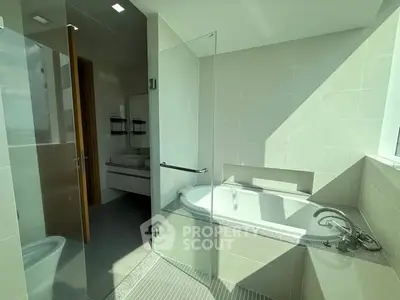 Luxurious bathroom with modern bathtub and glass shower enclosure