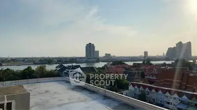Stunning rooftop view overlooking river and city skyline, perfect for urban living.