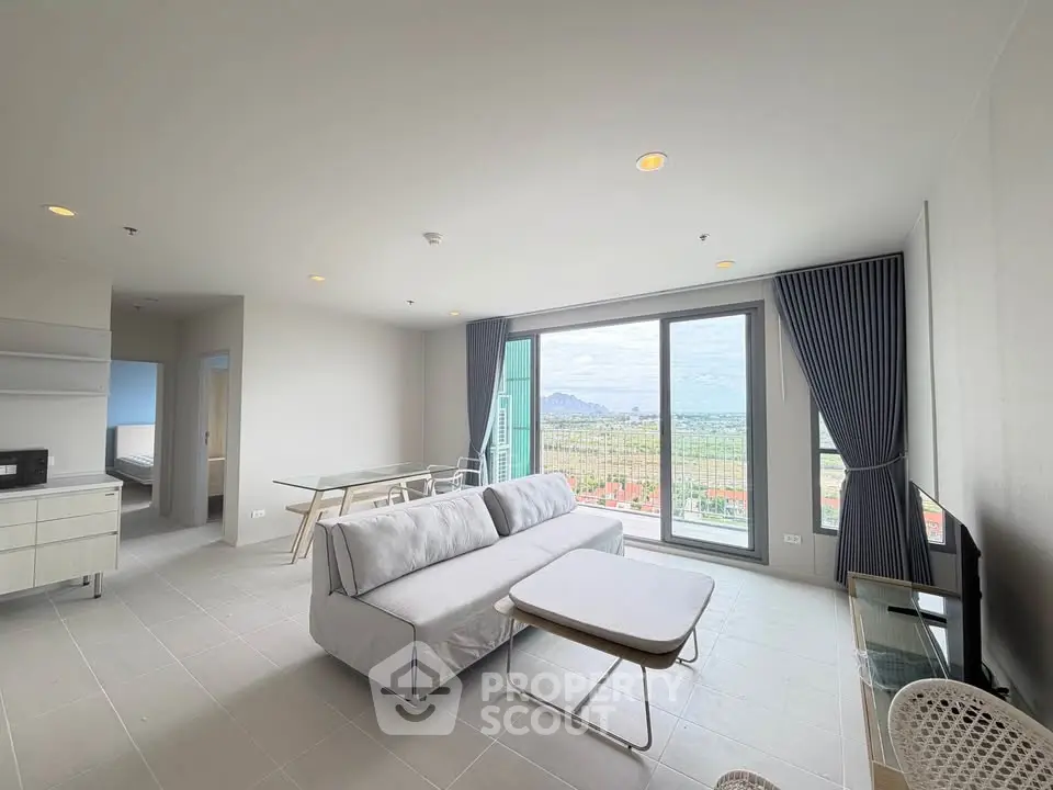 Spacious modern living room with panoramic view and elegant furnishings