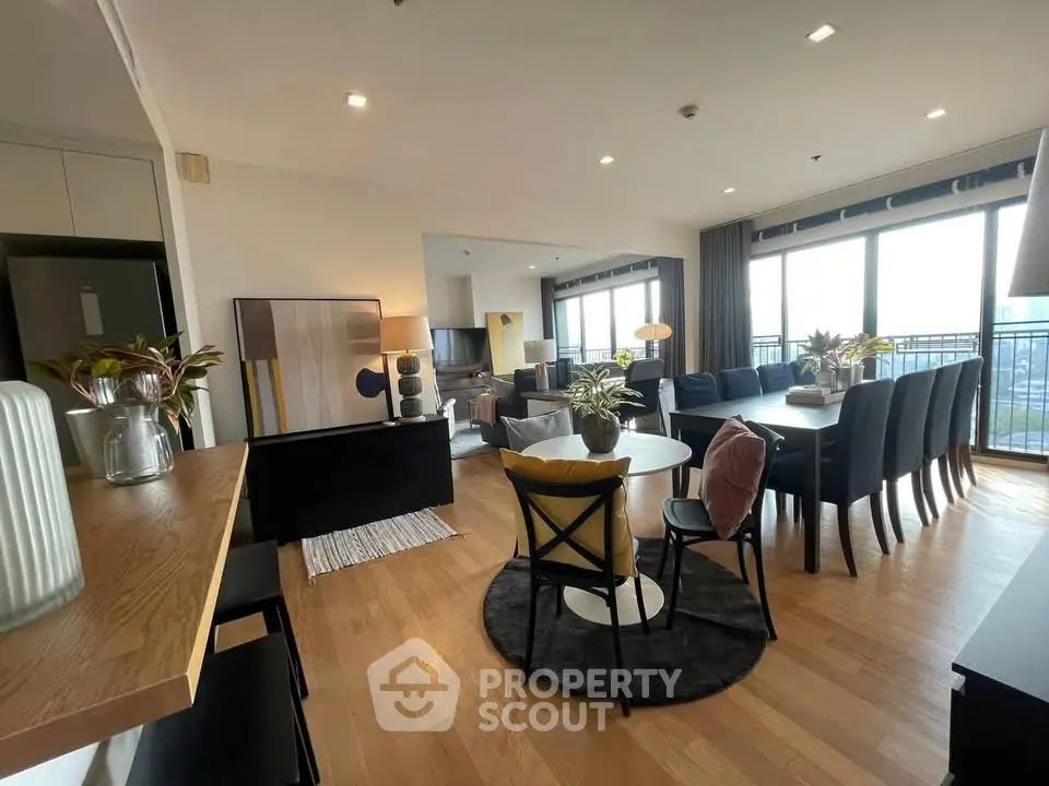 Spacious modern living and dining area with large windows and stylish decor