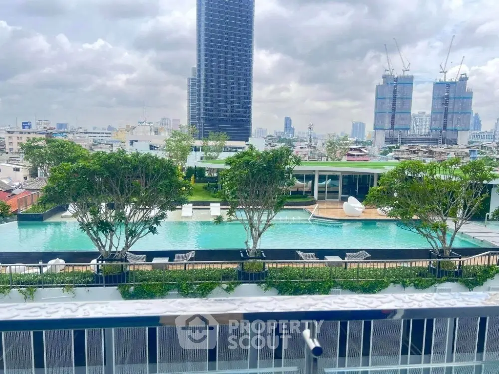 Luxurious rooftop pool with stunning city skyline views and lush greenery.
