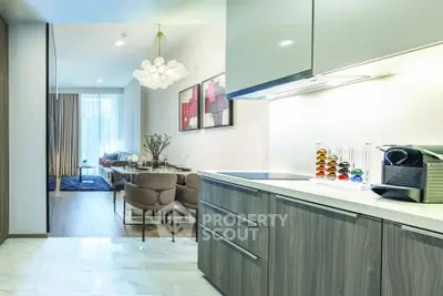 Modern open-plan kitchen and living room with stylish decor and natural light