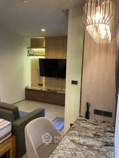 Modern living room with stylish lighting and wall-mounted TV