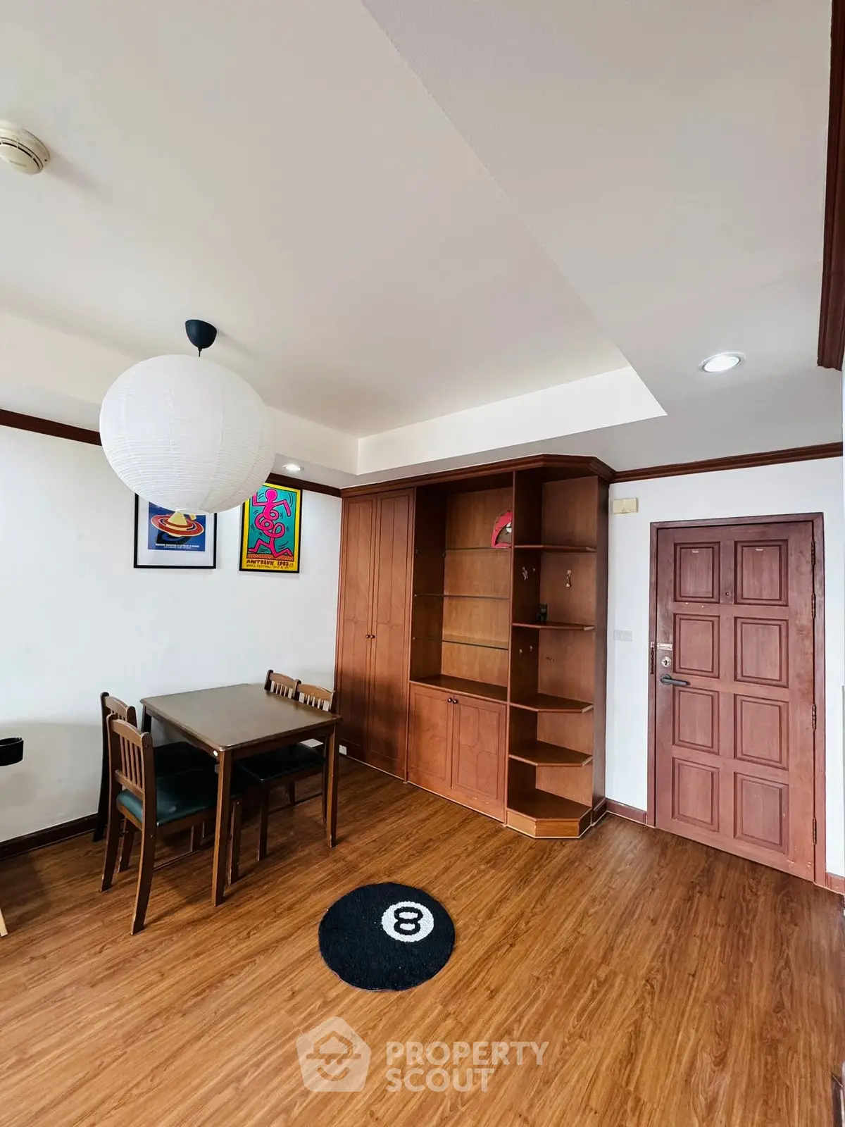 Charming dining area with wooden flooring and built-in storage, perfect for cozy meals.