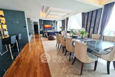 Luxurious open-plan living and dining area with elegant decor and large windows.