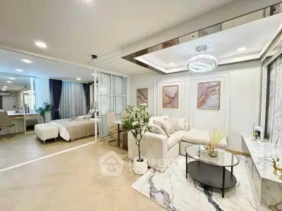 Luxurious open-plan living room with elegant decor and spacious bedroom view.