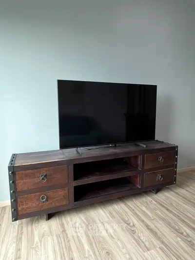 Stylish living room with modern TV stand and flat-screen TV on elegant wooden flooring.