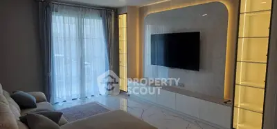 Luxurious living room with modern TV setup and elegant lighting