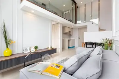 Modern duplex living room with stylish decor and open kitchen layout