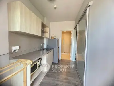 Modern kitchen with sleek cabinetry and stainless steel appliances in a compact layout.