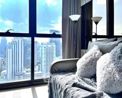 Luxurious living room with stunning city view and cozy decor