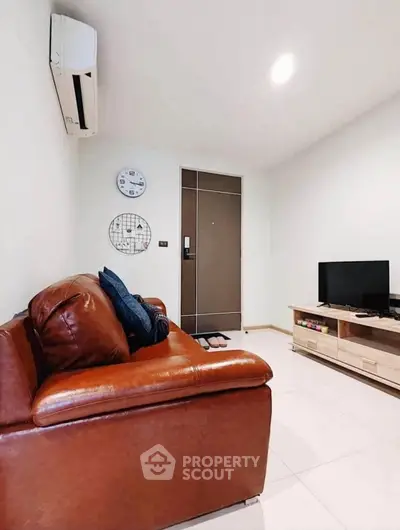 Cozy living room with leather sofa and modern entertainment unit