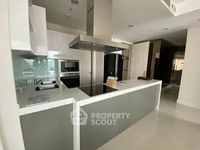 Modern kitchen with sleek design, featuring an island and built-in appliances, perfect for culinary enthusiasts.