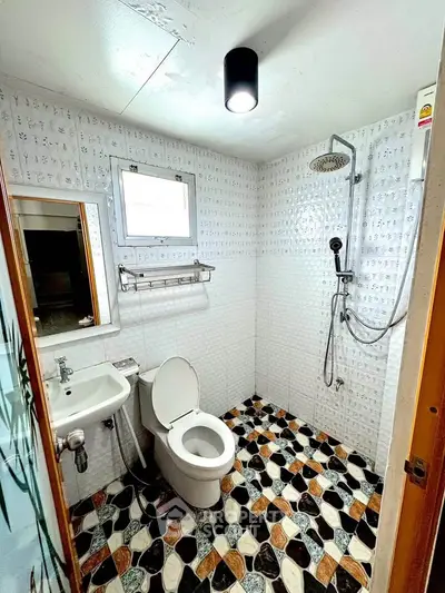 Modern bathroom with unique patterned tiles and rainfall showerhead
