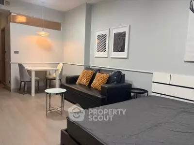 Modern studio apartment with stylish decor and cozy seating area
