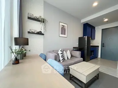 Modern living room with stylish decor and open kitchen in a contemporary apartment.