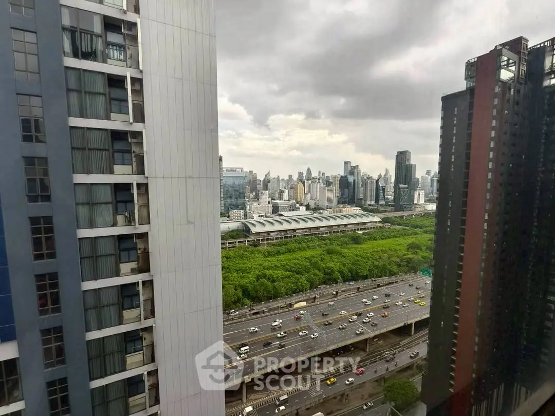 Stunning cityscape view from high-rise building overlooking highway and skyline.