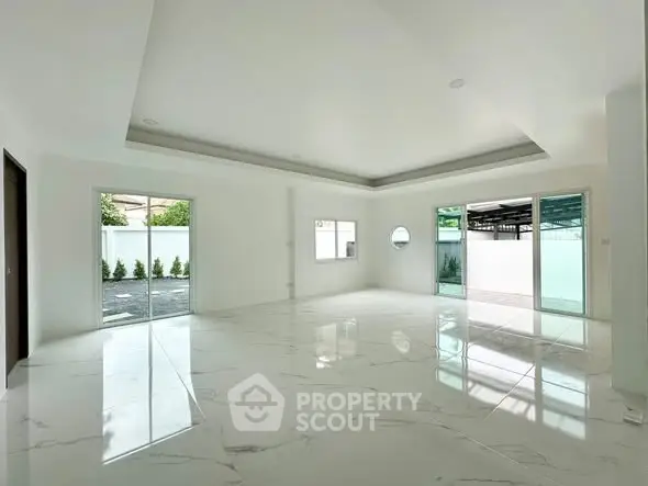 Spacious modern living room with marble flooring and large windows