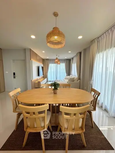 Spacious living room with elegant dining area and natural light