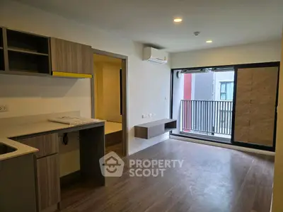 Modern apartment interior with open kitchen and balcony view