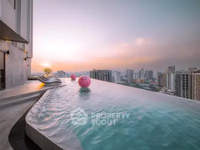 Luxurious rooftop infinity pool with stunning city skyline view at sunset