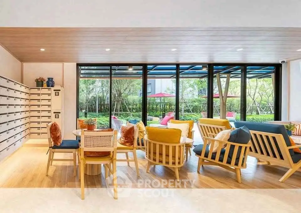 Stylish modern living area with vibrant seating and large windows overlooking lush greenery.
