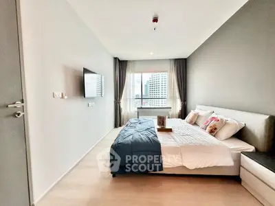 Modern bedroom with city view, featuring sleek design and cozy ambiance.