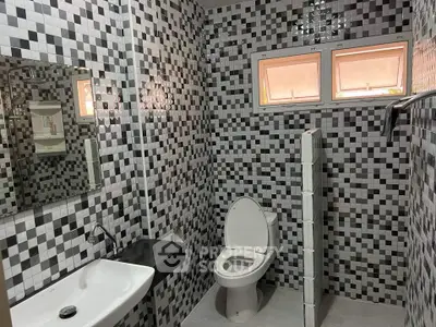 Modern bathroom with mosaic tiles and sleek fixtures