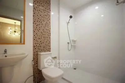 Modern bathroom with sleek fixtures and stylish tile accent wall.