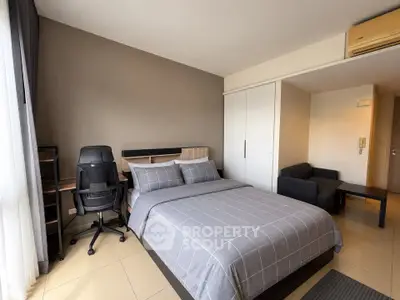 Modern bedroom with stylish decor, cozy bed, and workspace in a bright apartment.