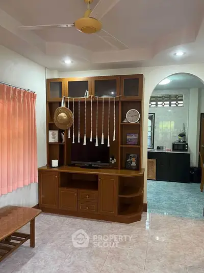 Charming living room with wooden entertainment center and cozy decor