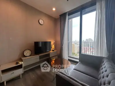 Modern living room with city view, featuring sleek furniture and large windows for natural light.
