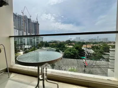 Spacious balcony with stunning cityscape view, perfect for relaxation and enjoying urban living.