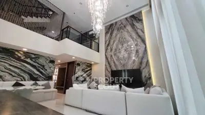 Luxurious modern living room with high ceilings and elegant marble accents