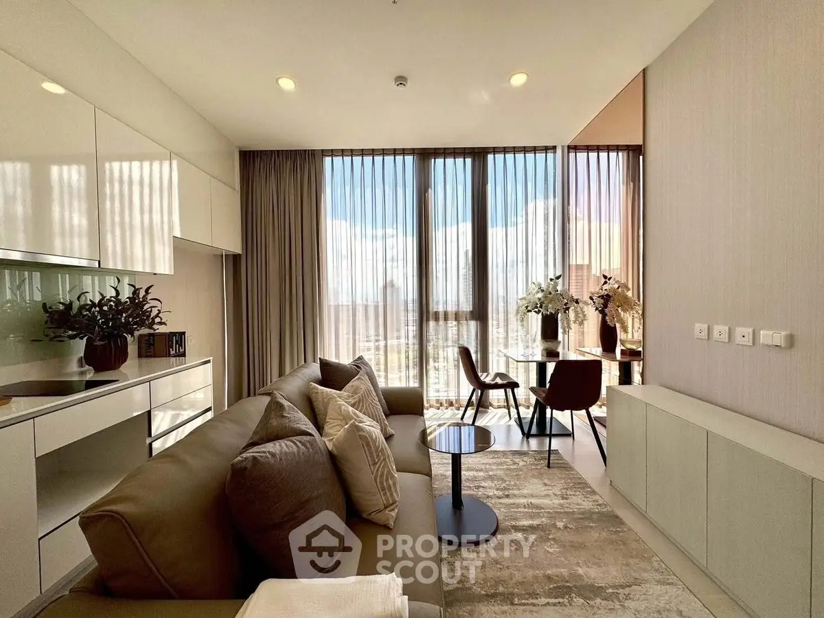 Modern living room with large windows and stylish decor in a high-rise apartment.