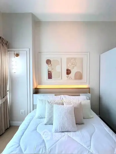 Elegant bedroom with modern decor and cozy bedding in a bright, stylish apartment.
