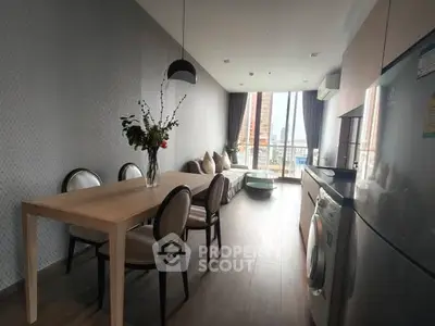 Modern open-layout living room with dining area and city view, featuring sleek furniture and contemporary design.