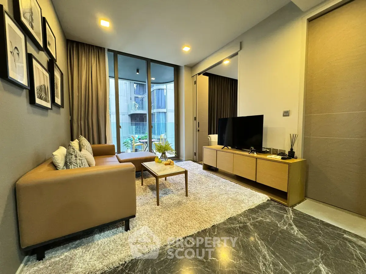 Modern living room with stylish decor and large windows in a contemporary apartment.