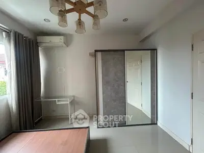 Spacious bedroom with modern lighting and large mirrored wardrobe