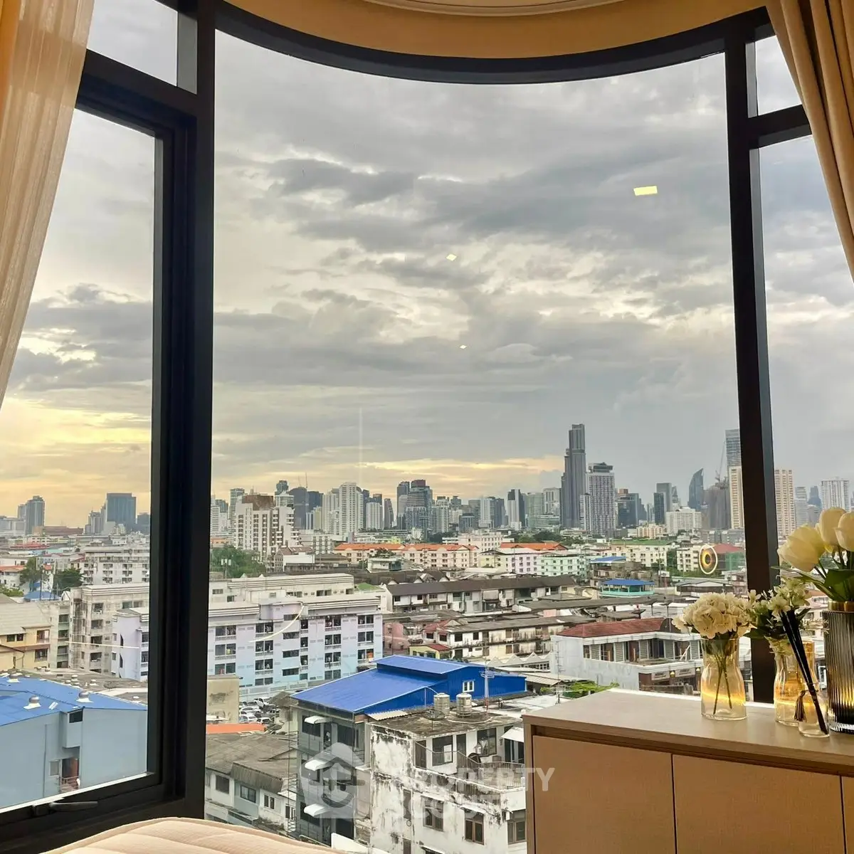 Stunning cityscape view from a modern apartment window, showcasing urban skyline.